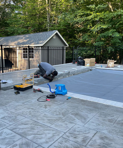 A man working on a pool.