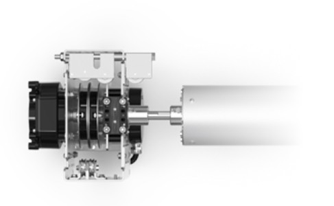 A side view of a mechanical device with visible gears and components on the left, connected to a cylindrical metallic part on the right, fading into a white background.