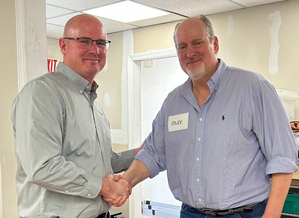 Adam Marble, CEO of CoverSafe, and Mark Sheinman, Owner of Pennco shaking hands