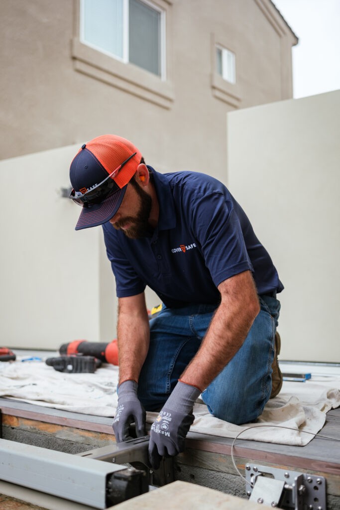 CoverSafe Automatic Pool Cover Service Technician Performing Maintenance on a Cover