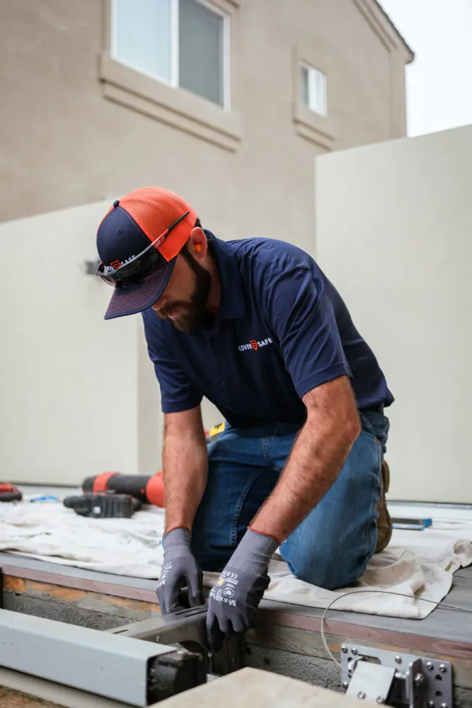 CoverSafe Automatic Pool Cover Service Technician Performing Maintenance on a Cover